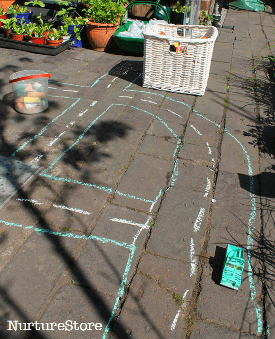 using chalk to draw a town for imaginary play