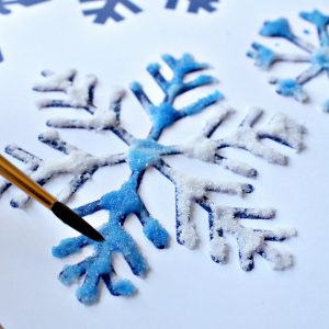 Salt, glue and watercolor painting to make snowflake art - NurtureStore