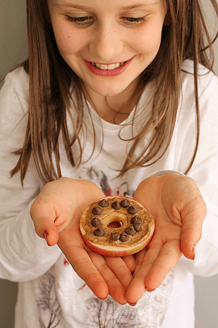 child holding apple cookie